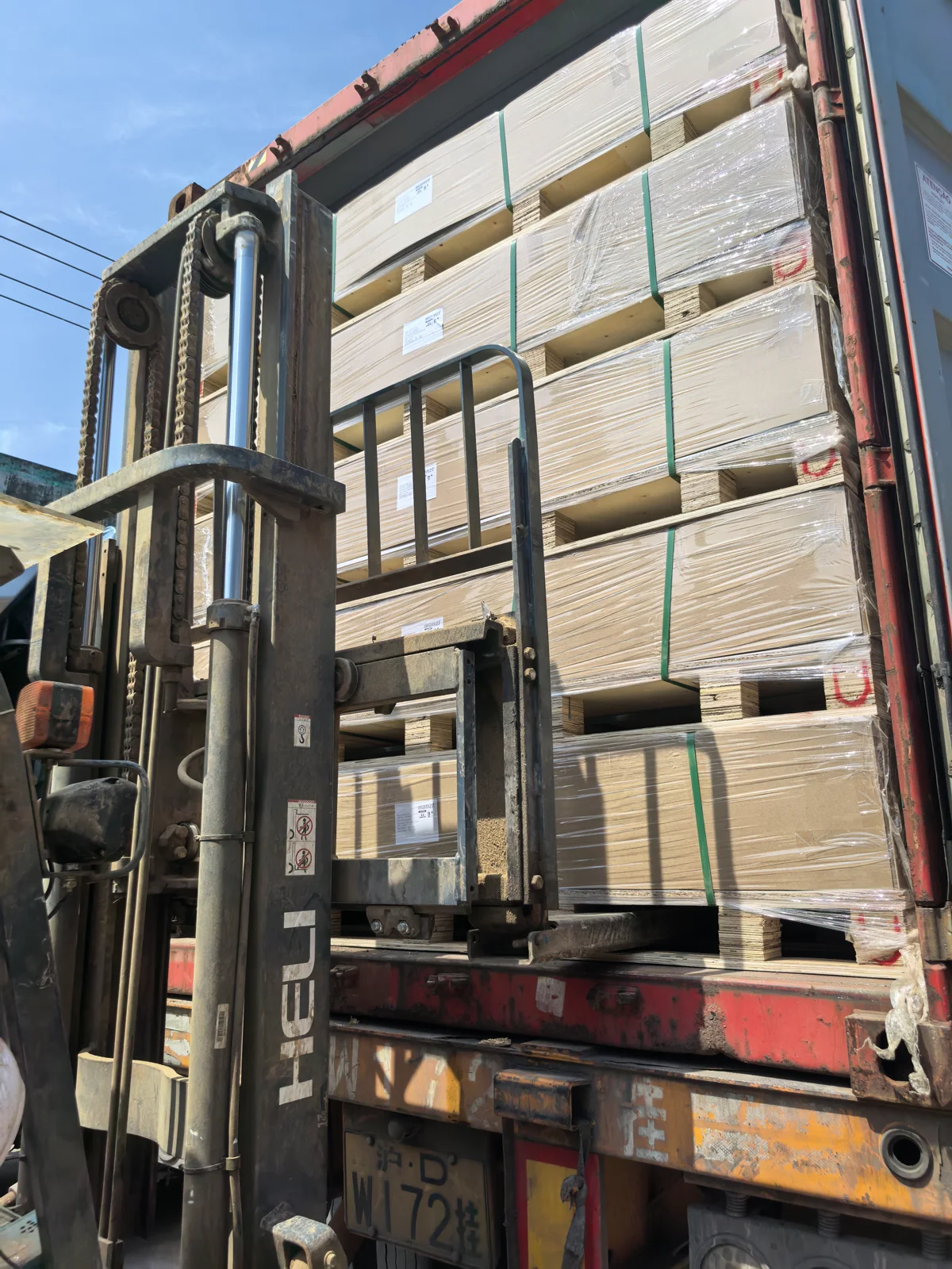 Packed slatwall pallets being loaded into a container